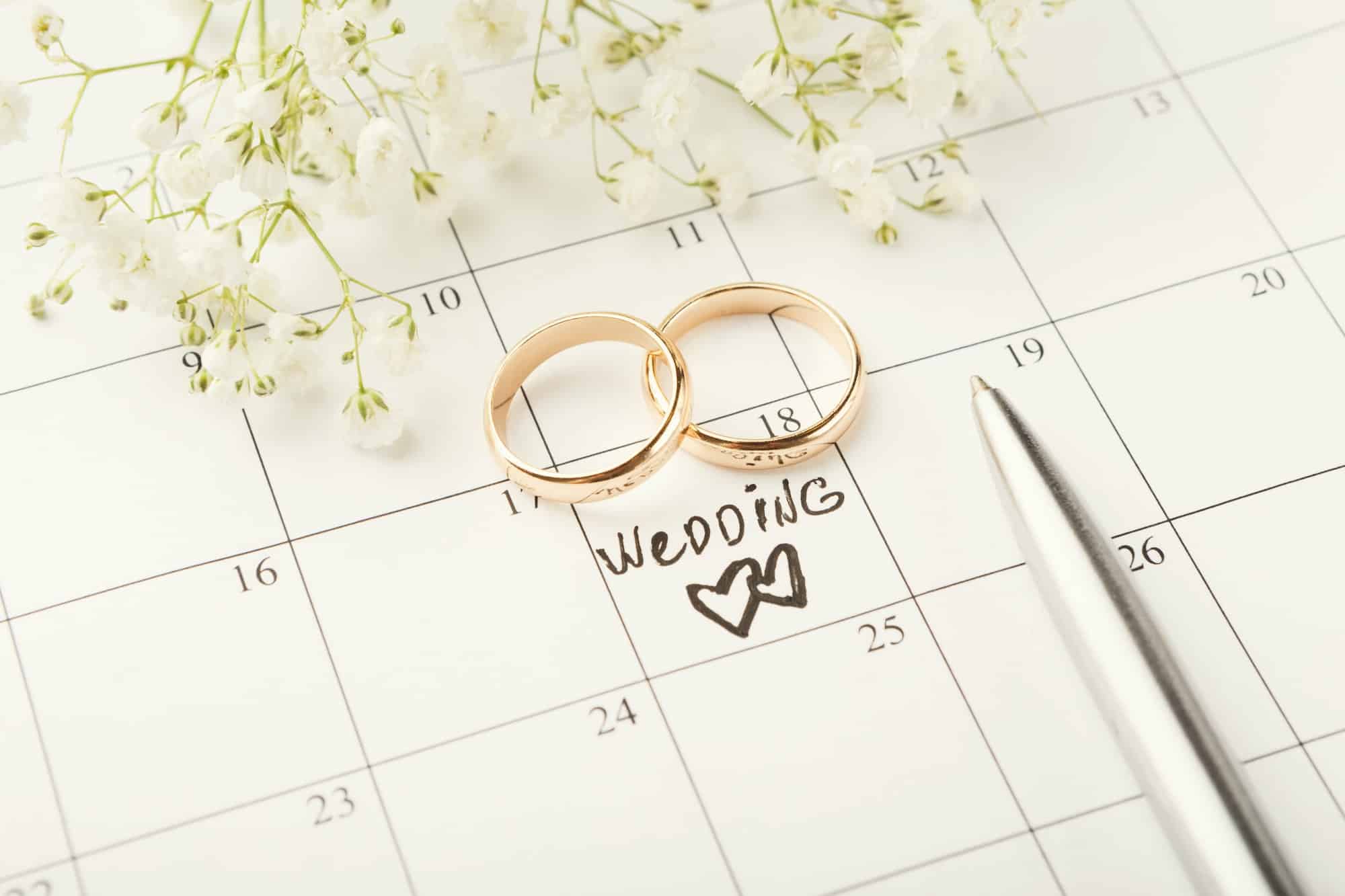 Word wedding on calendar with sweet flowers